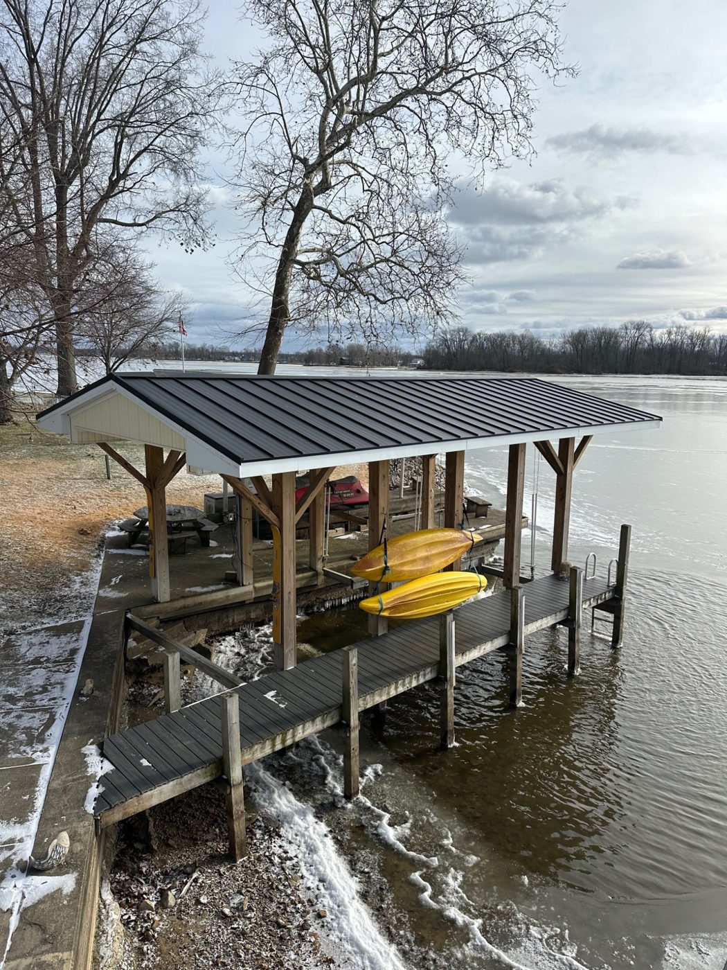 Finished standing seam roof on a lakeside boat shelter