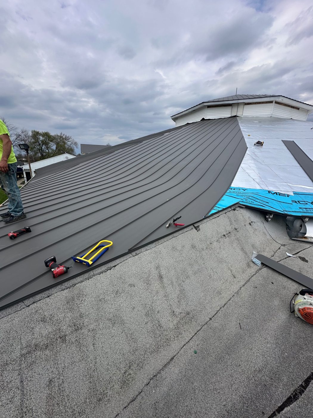Large white building with completed metal roof